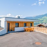 Exterior view of the Hoferlitzlhubgut, a spacious vacation home in Mittersill for up to 10 people, surrounded by a picturesque mountain landscape. thumbnail